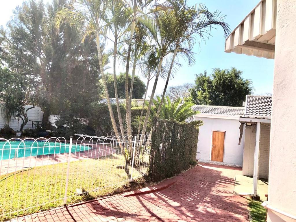 Garden pathway with palm trees beside the pool